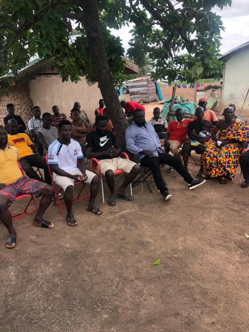 Community stakeholders seated under a tree during a rural Ghana engagement meeting
